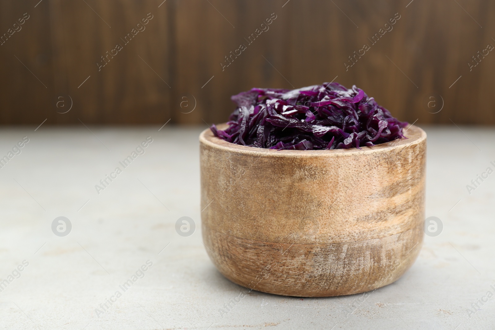 Photo of Tasty red cabbage sauerkraut on table. Space for text