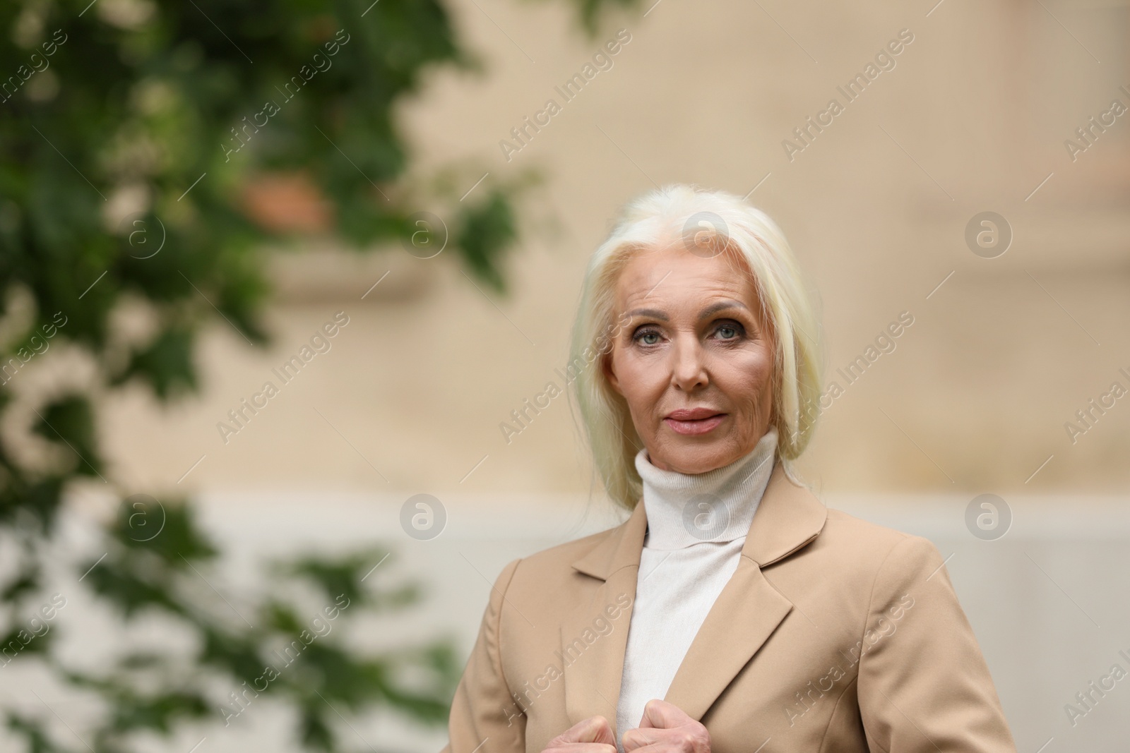 Photo of Portrait of elegant mature woman on city street