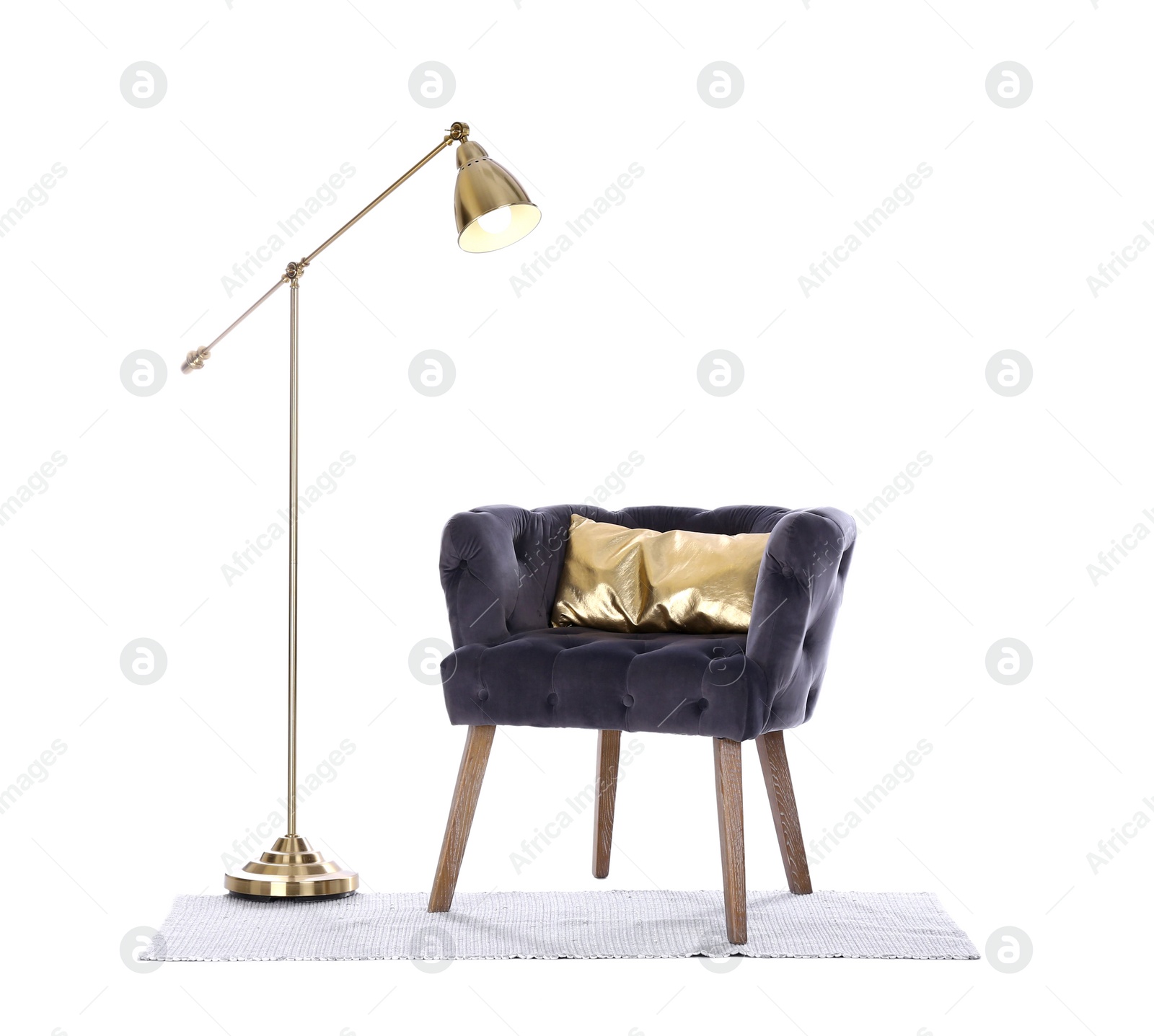 Photo of Comfortable armchair, rug and lamp isolated on white