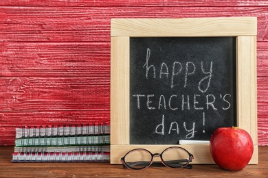 Photo of Composition with small chalkboard for Teacher's day on table