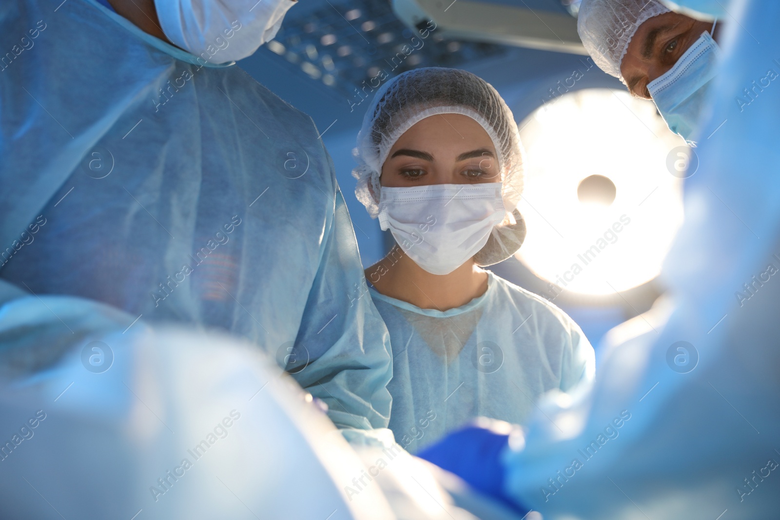 Photo of Team of professional surgeons performing operation in clinic