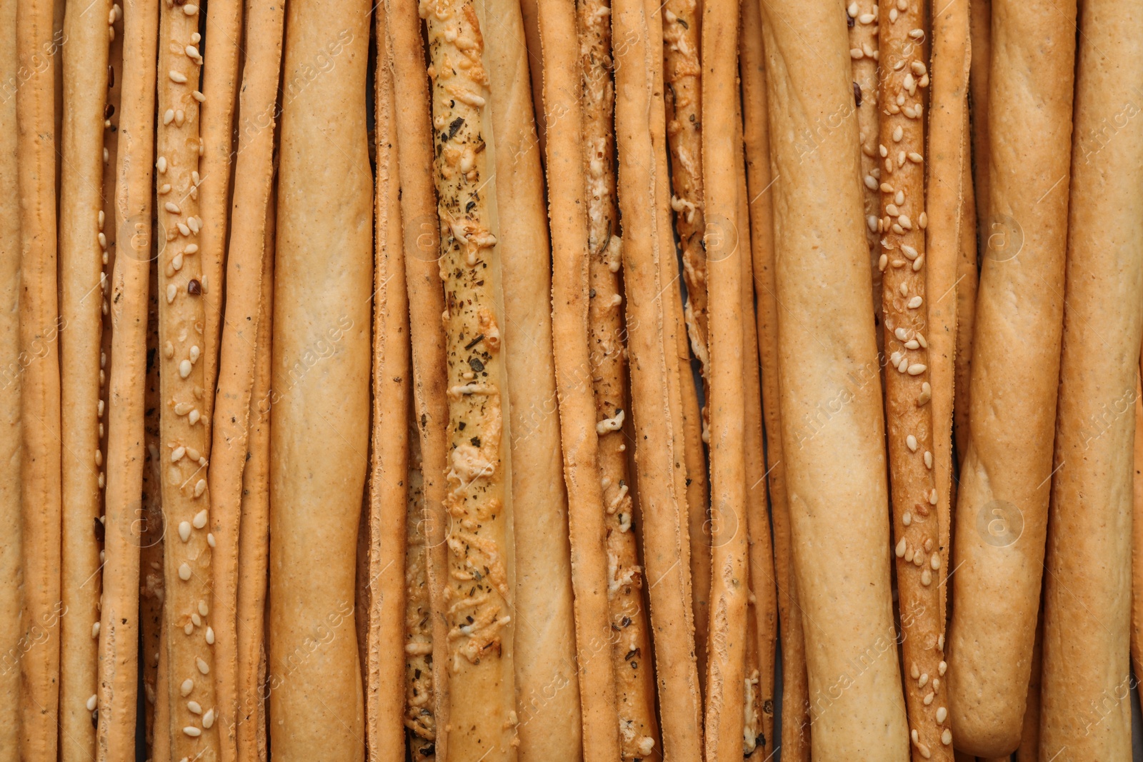 Photo of Delicious grissini sticks as background, top view