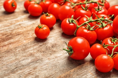 Photo of Fresh ripe red tomatoes on wooden table