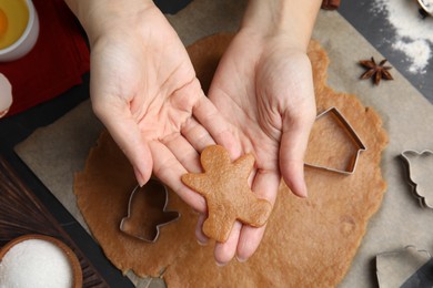 Photo of Woman making Christmas cookies at table, top view