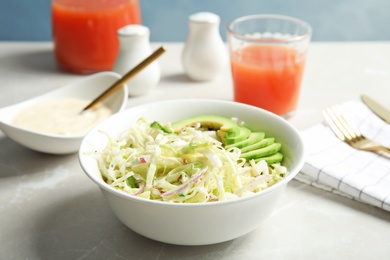 Photo of Bowl with healthy cabbage salad on marble table