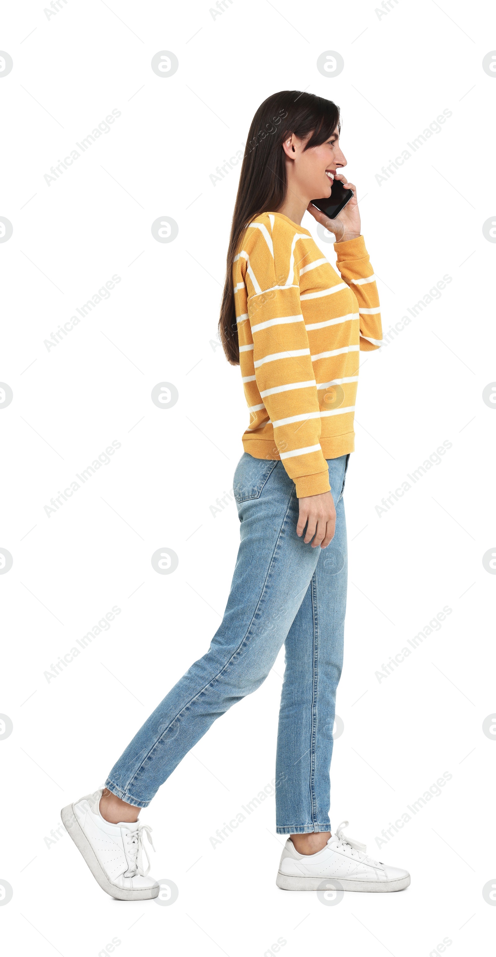 Photo of Happy woman talking on smartphone against white background