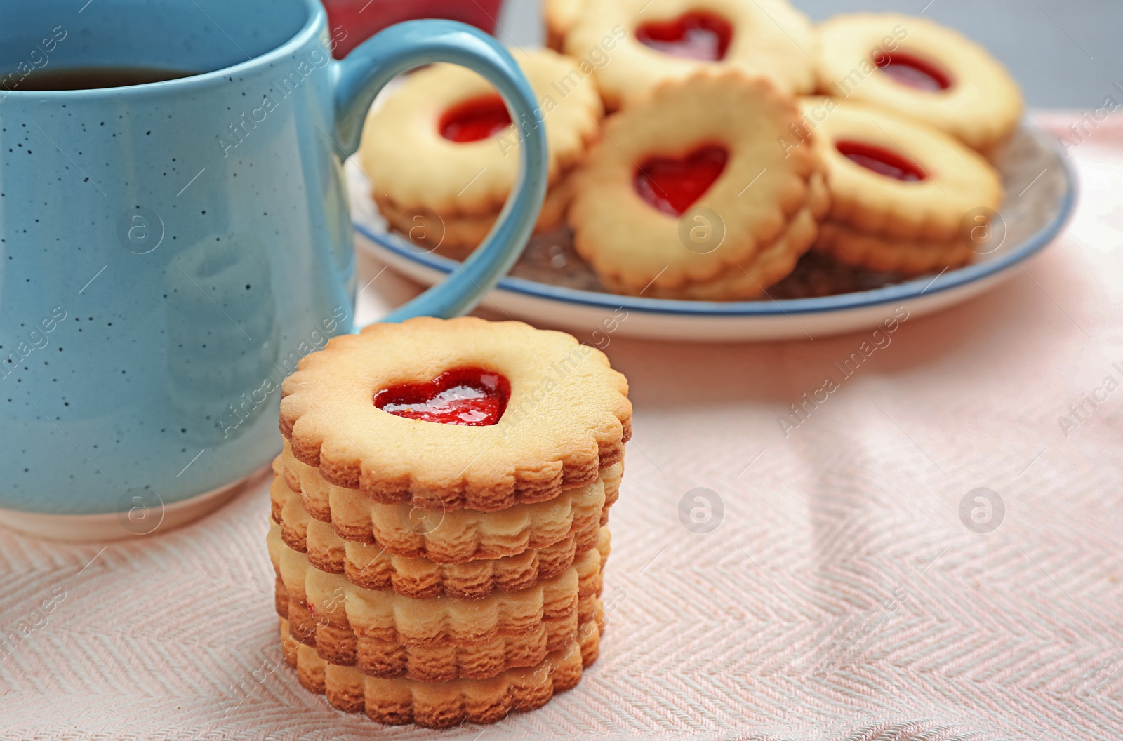 Photo of Traditional Christmas Linzer cookies with sweet jam on table