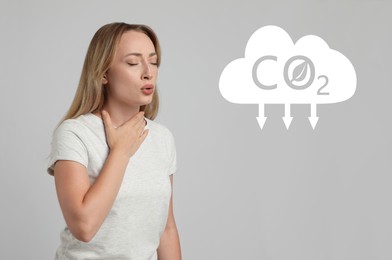 Image of Reduce CO2 emissions. Young woman suffering from pain during breathing on light grey background