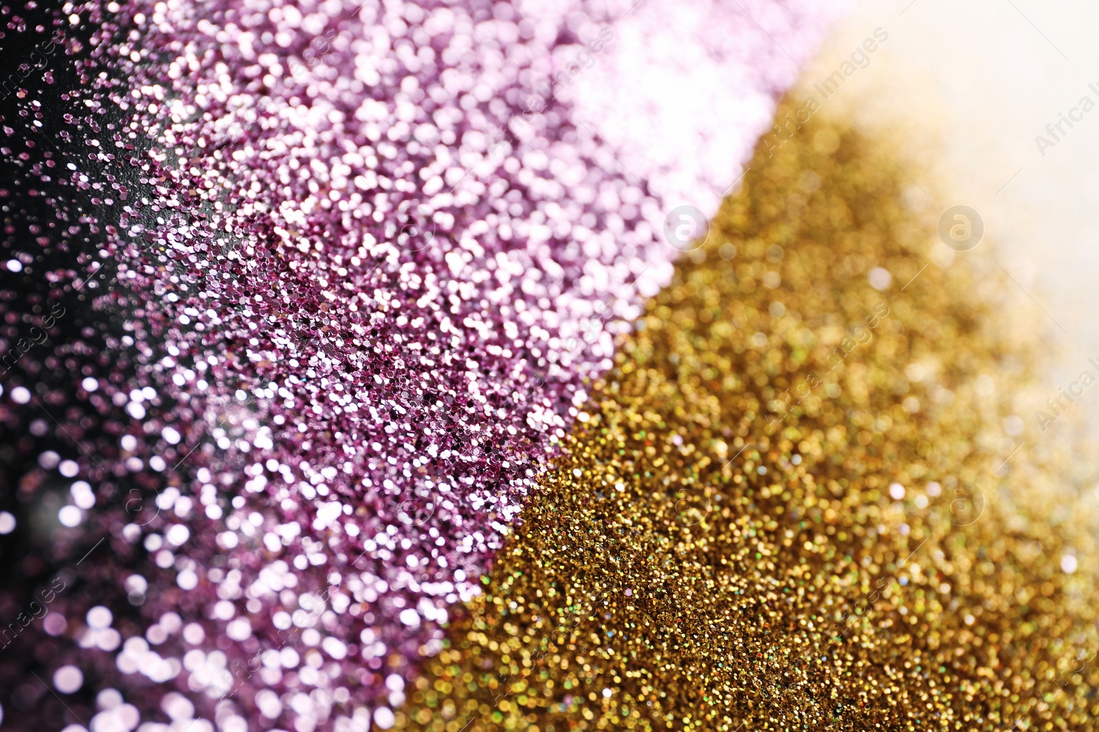 Photo of Gold and rose glitter as background, closeup