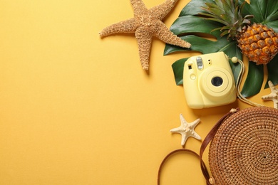 Flat lay composition with bag and camera on color background, space for text. Beach accessories