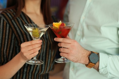 Photo of Young couple with tasty martini cocktails, closeup