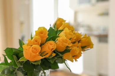 Photo of Beautiful bouquet of yellow roses indoors, closeup