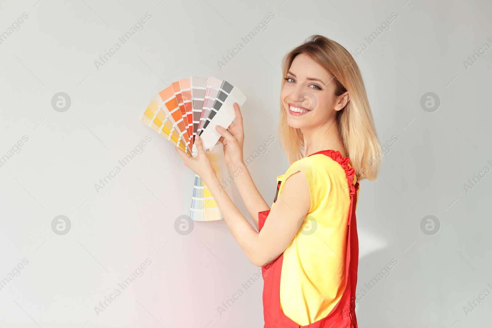 Photo of Female decorator with color palette on white background