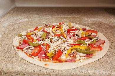 Photo of Uncooked pizza with different toppings on table. Oven recipe