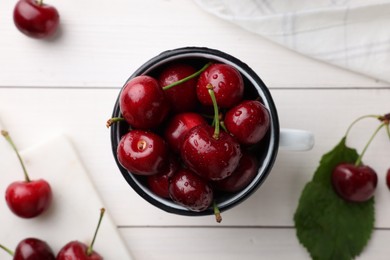 Photo of Fresh ripe cherries with water drops on white wooden table, flat lay