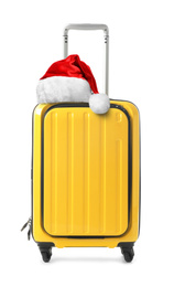 Image of Stylish suitcase with Santa Claus hat isolated on white. Christmas vacation 