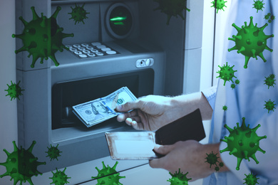 Use cash machine careful during coronavirus outbreak. Man withdrawing money at ATM