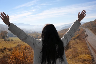 Female traveler feeling free in peaceful mountains