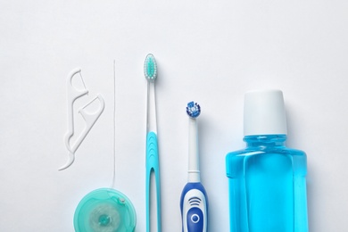 Photo of Flat lay composition with toothbrushes and oral hygiene products on white background