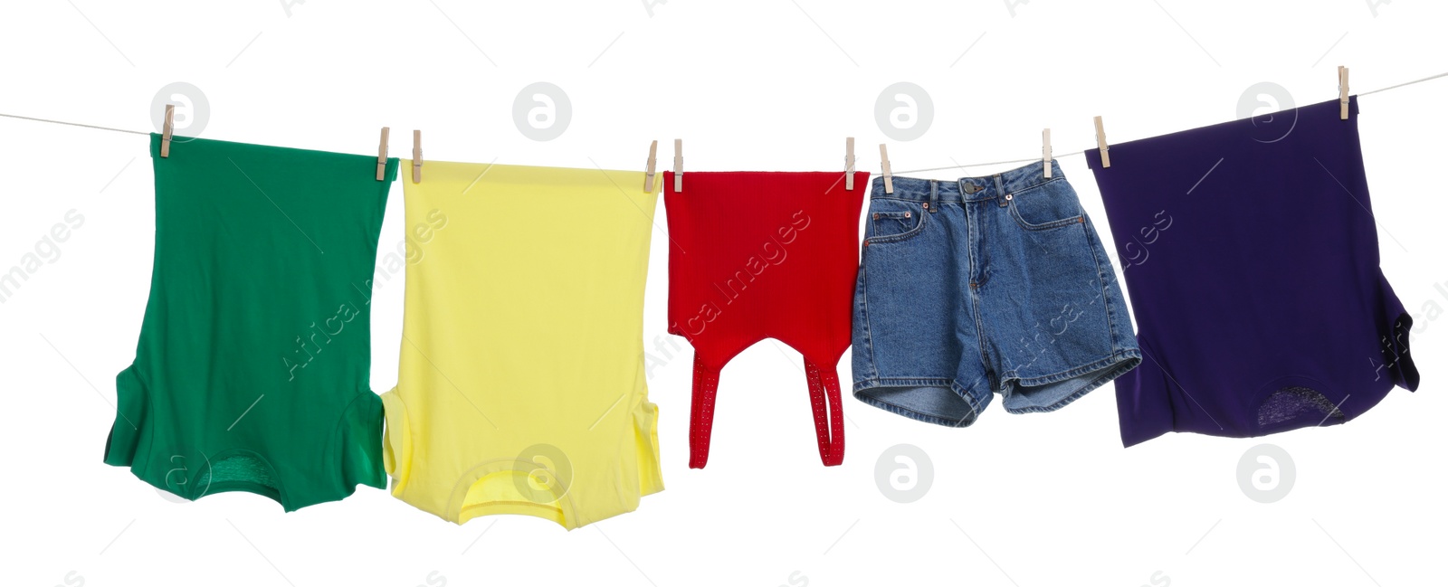 Photo of Different clothes drying on laundry line against white background