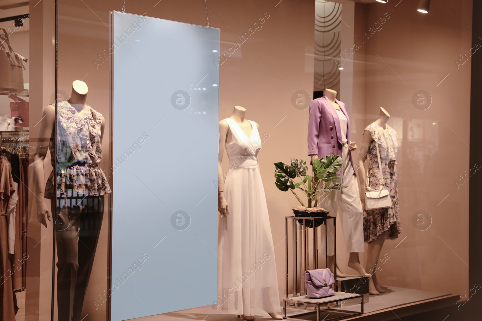 Photo of Beautiful clothes on mannequins in showcases of fashion store