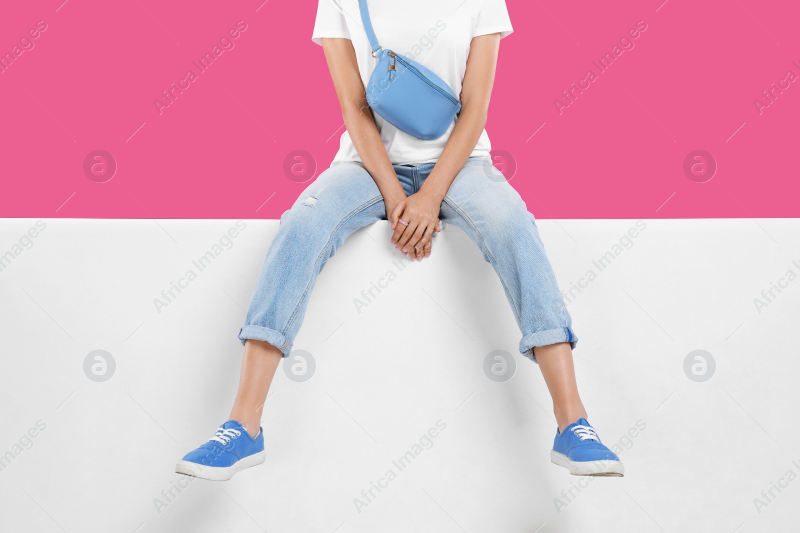 Photo of Woman wearing stylish shoes on color background, closeup