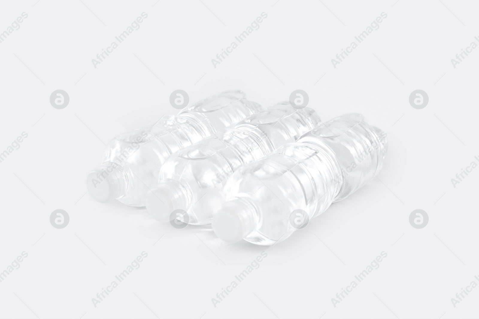 Photo of Plastic bottles with pure water on white background