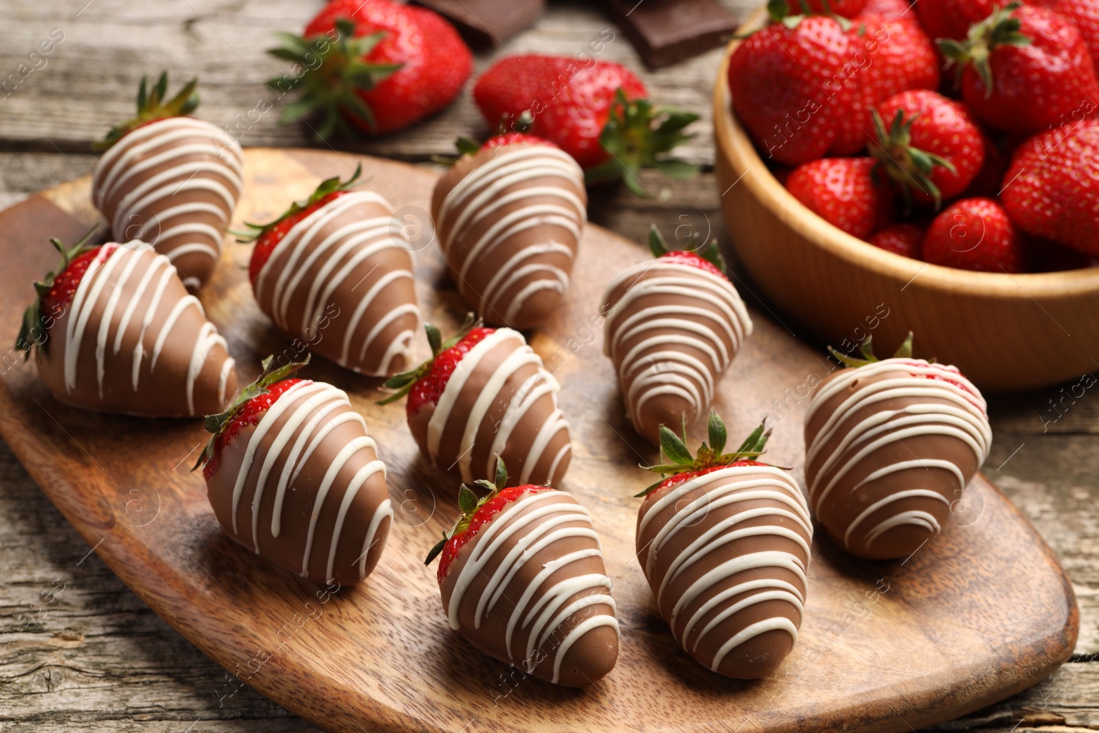 Photo of Delicious chocolate covered strawberries on wooden table, closeup