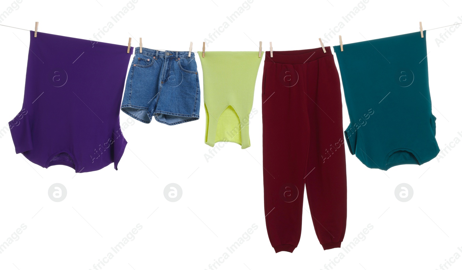 Photo of Different clothes drying on laundry line against white background