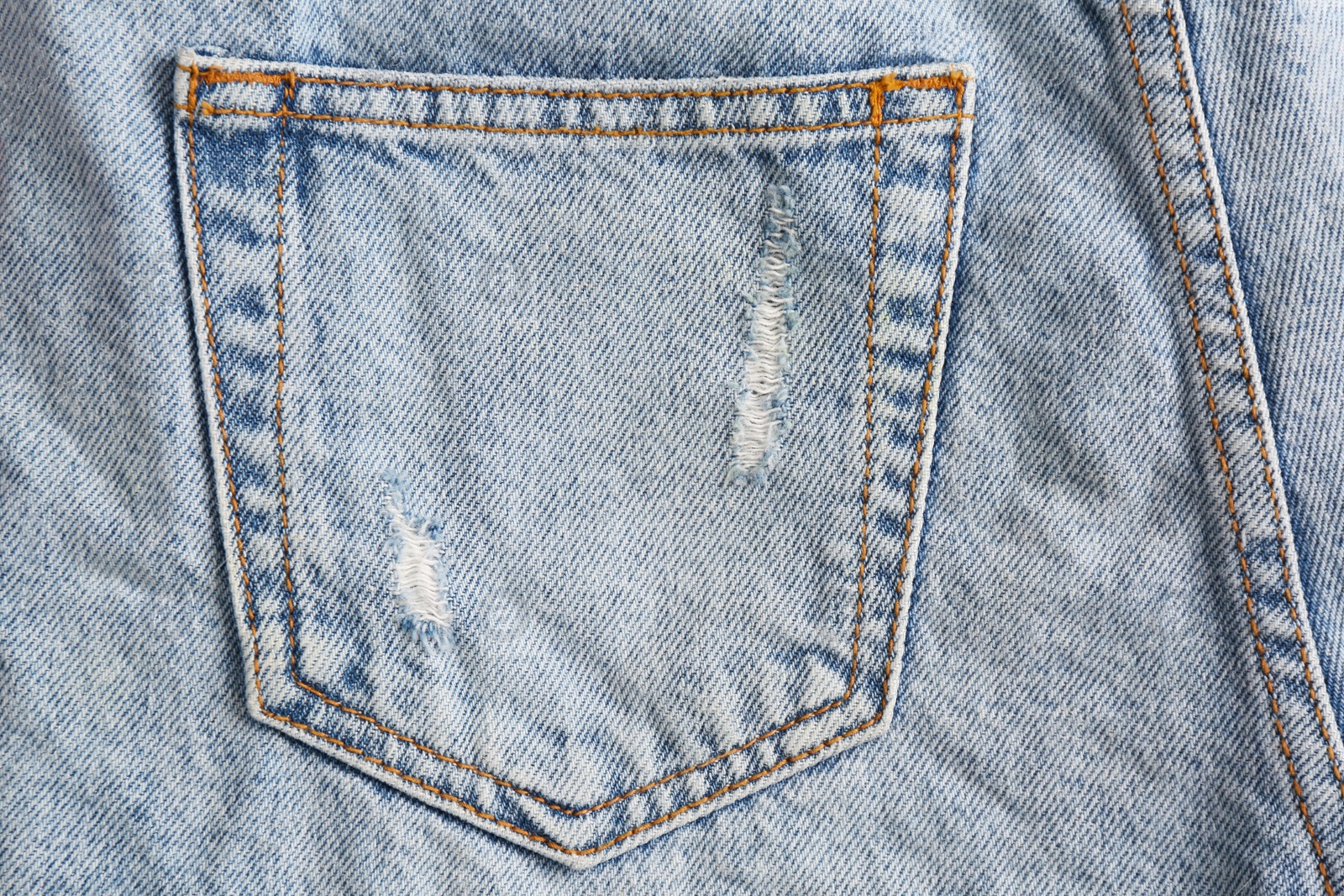 Photo of Light blue jeans with back pocket as background, closeup