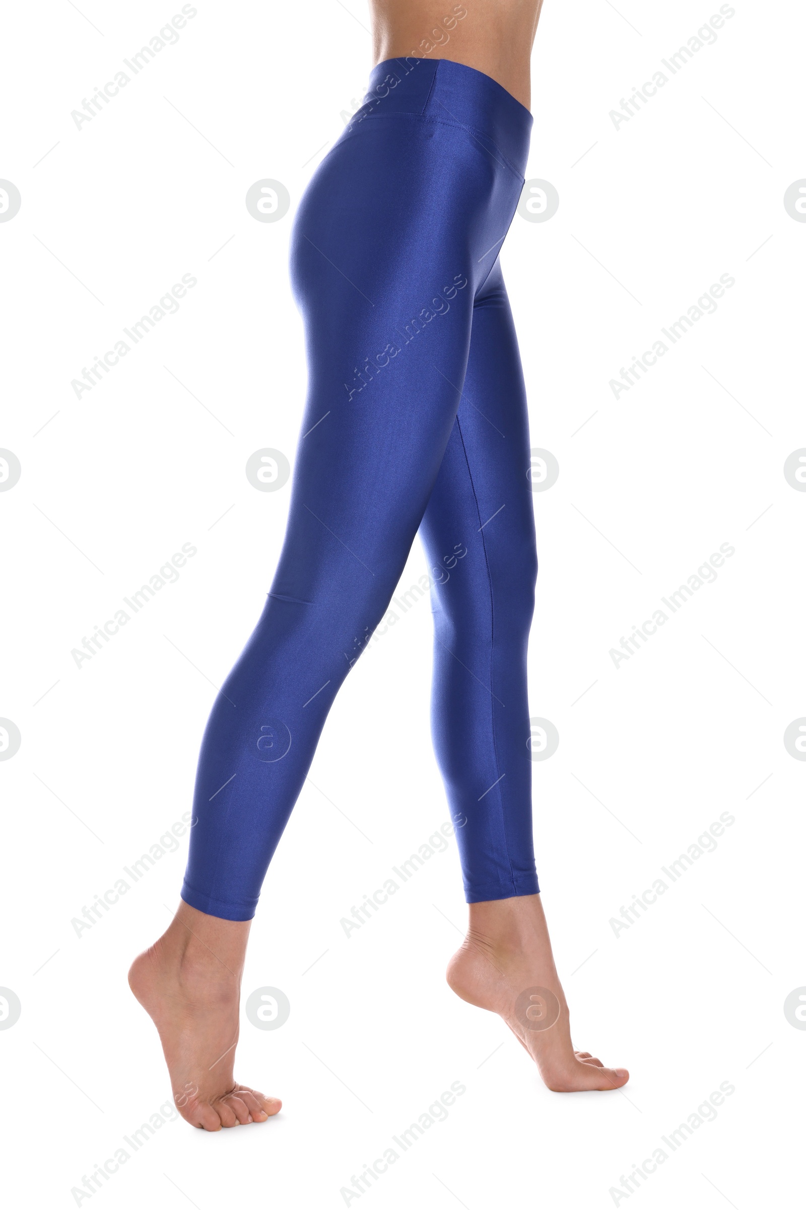 Photo of Woman with beautiful long legs wearing blue leggings on white background, closeup