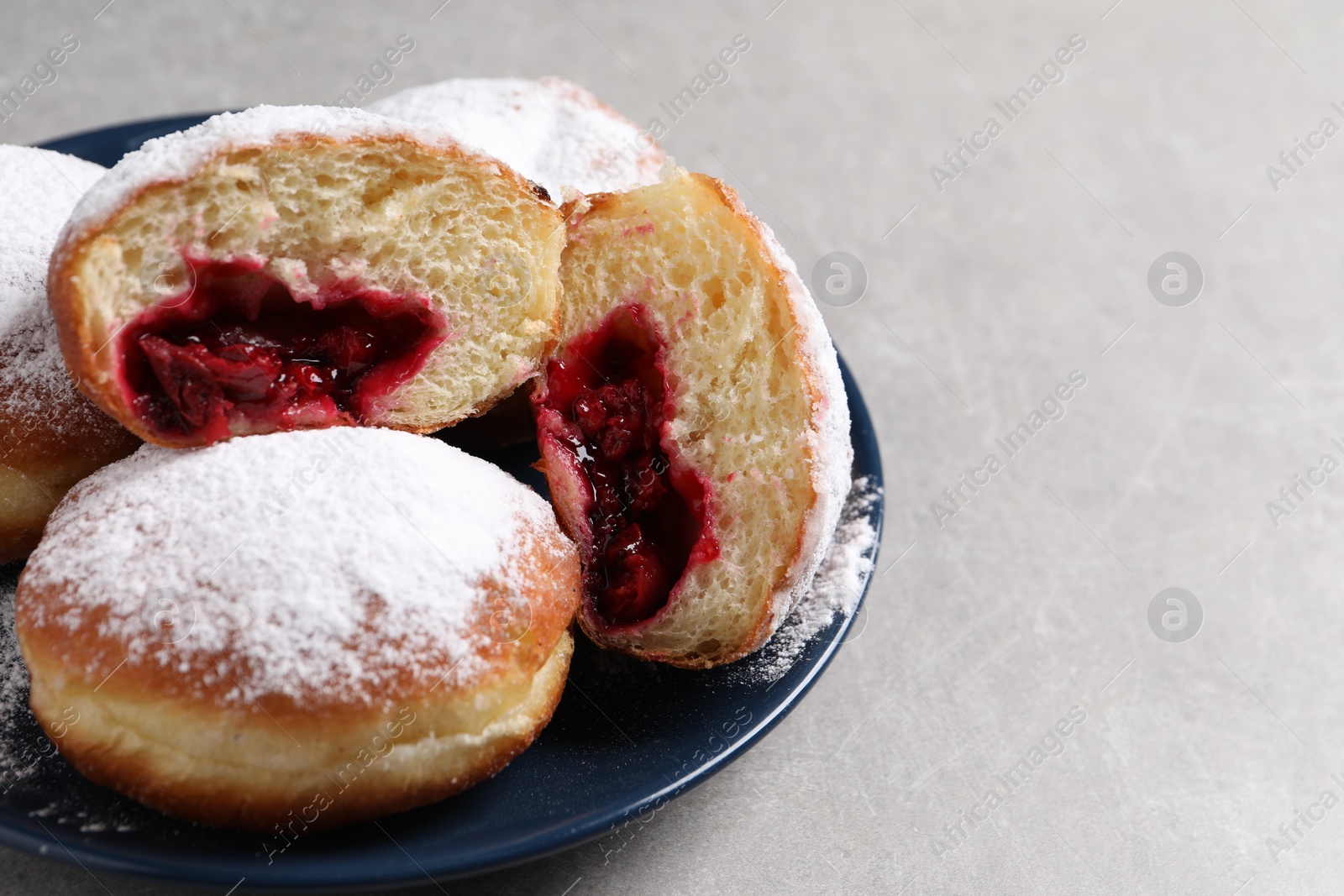 Photo of Delicious sweet buns with cherries on gray table, closeup. Space for text