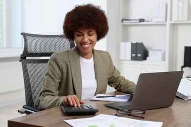 Photo of Professional accountant working at wooden desk in office