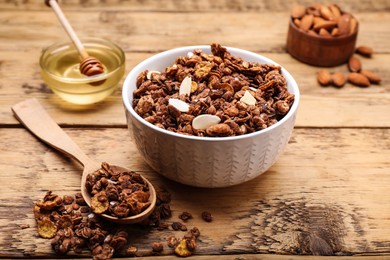 Tasty granola served with nuts and dry fruits on wooden table