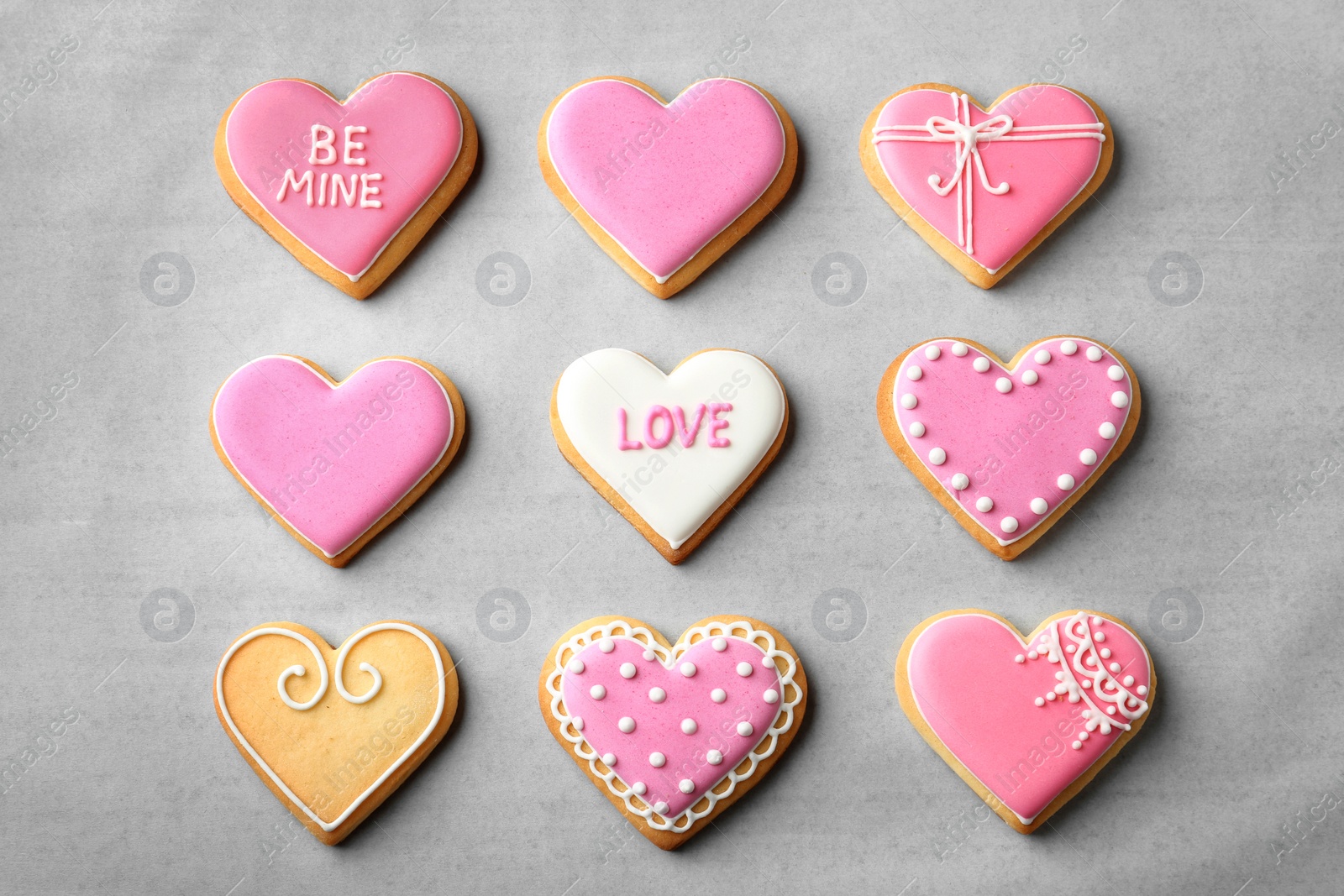 Photo of Decorated heart shaped cookies on color background, top view. Valentine's day treat