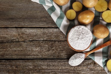 Photo of Starch and fresh raw potatoes on wooden table, flat lay. Space for text