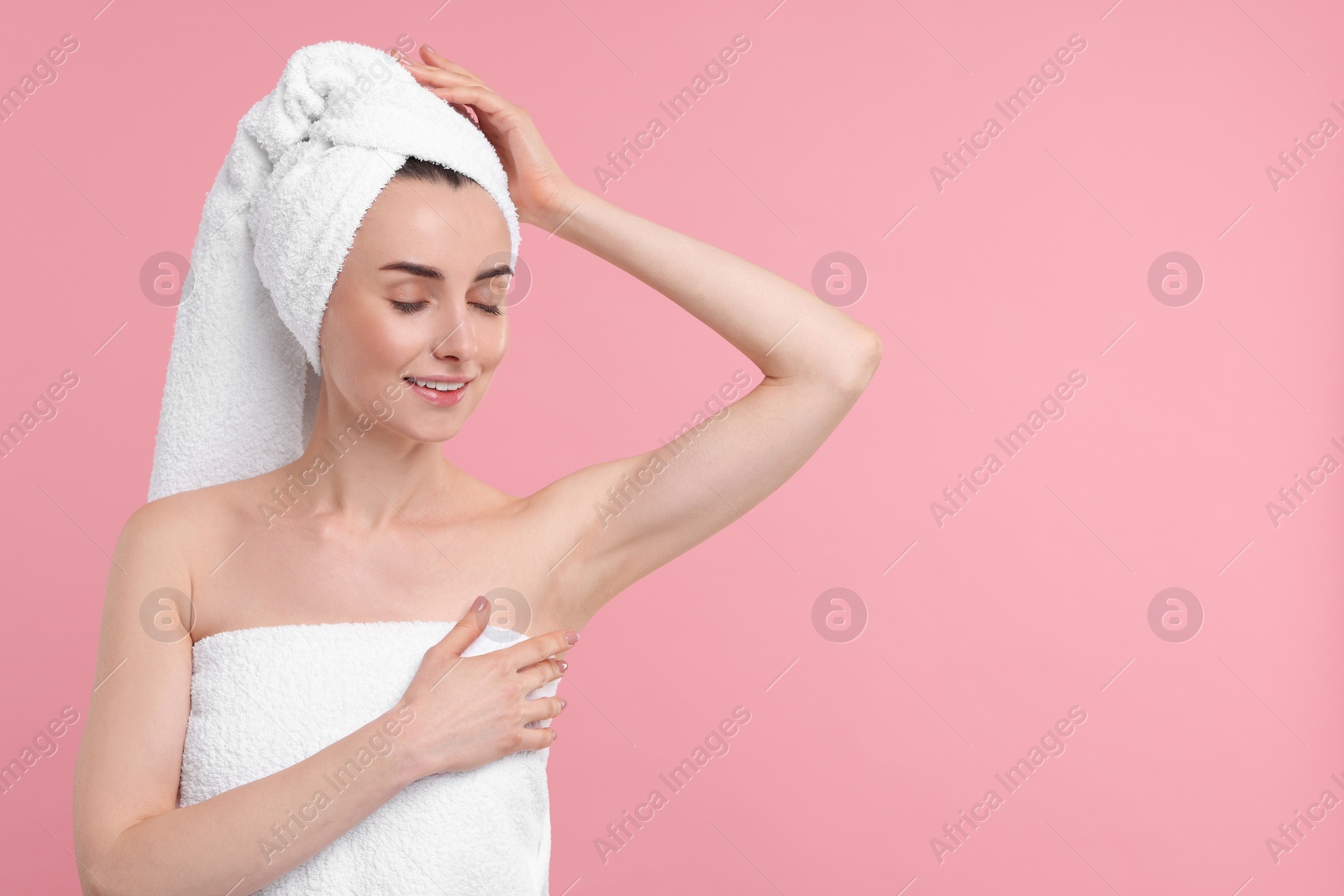 Photo of Beautiful woman showing armpit with smooth clean skin on pink background, space for text