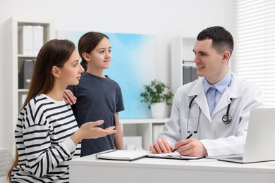 Photo of Gastroenterologist consulting woman and her daughter in clinic