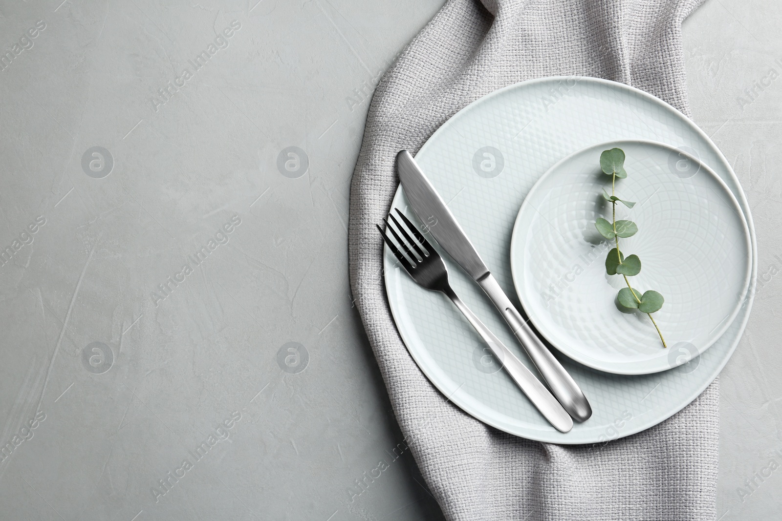 Photo of Stylish elegant table setting on light background, top view. Space for text