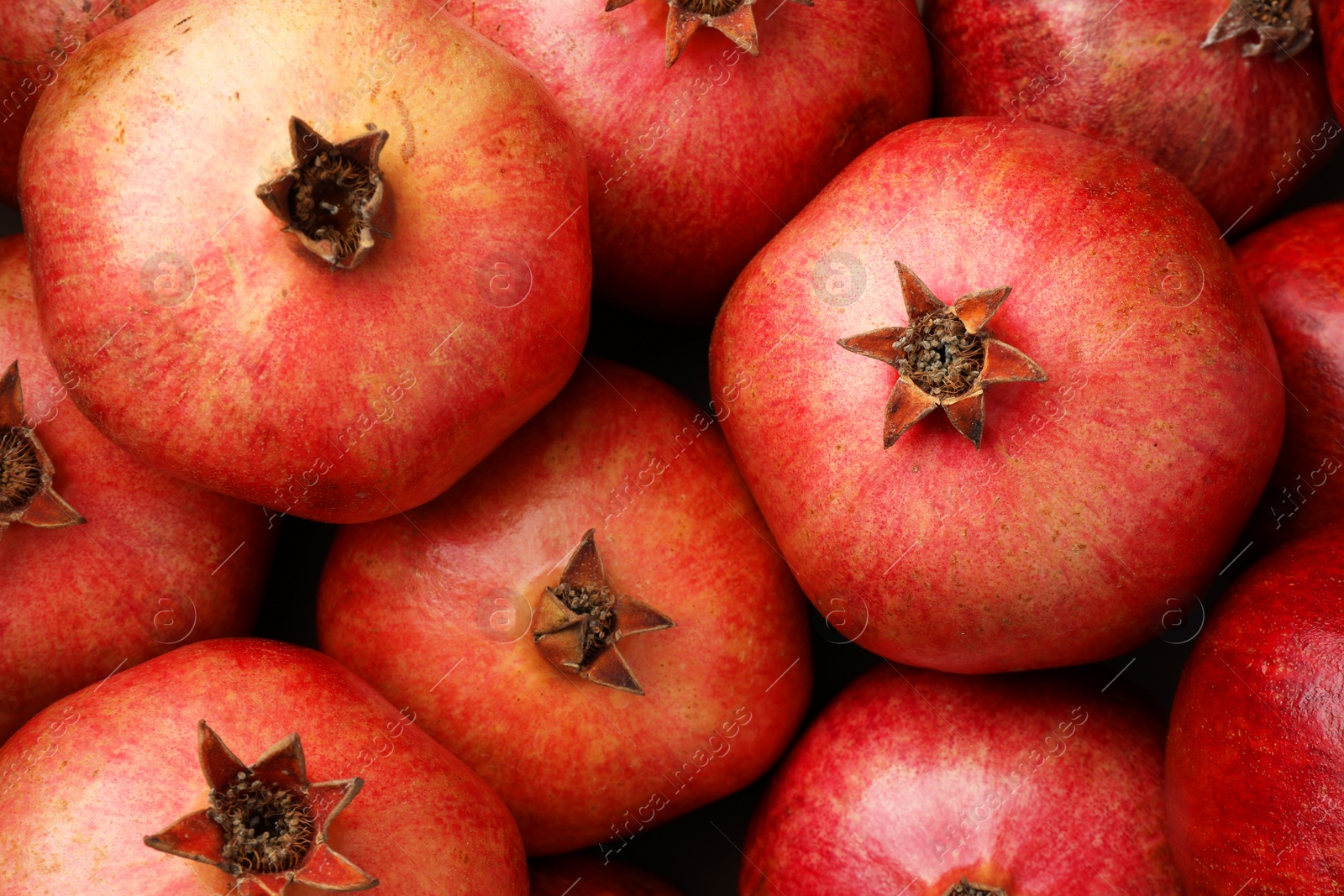 Photo of Fresh ripe pomegranates as background, top view