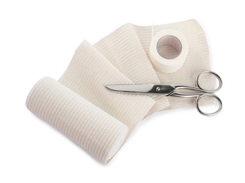 Photo of Medical bandage roll, sticking plaster and scissors on white background, above view