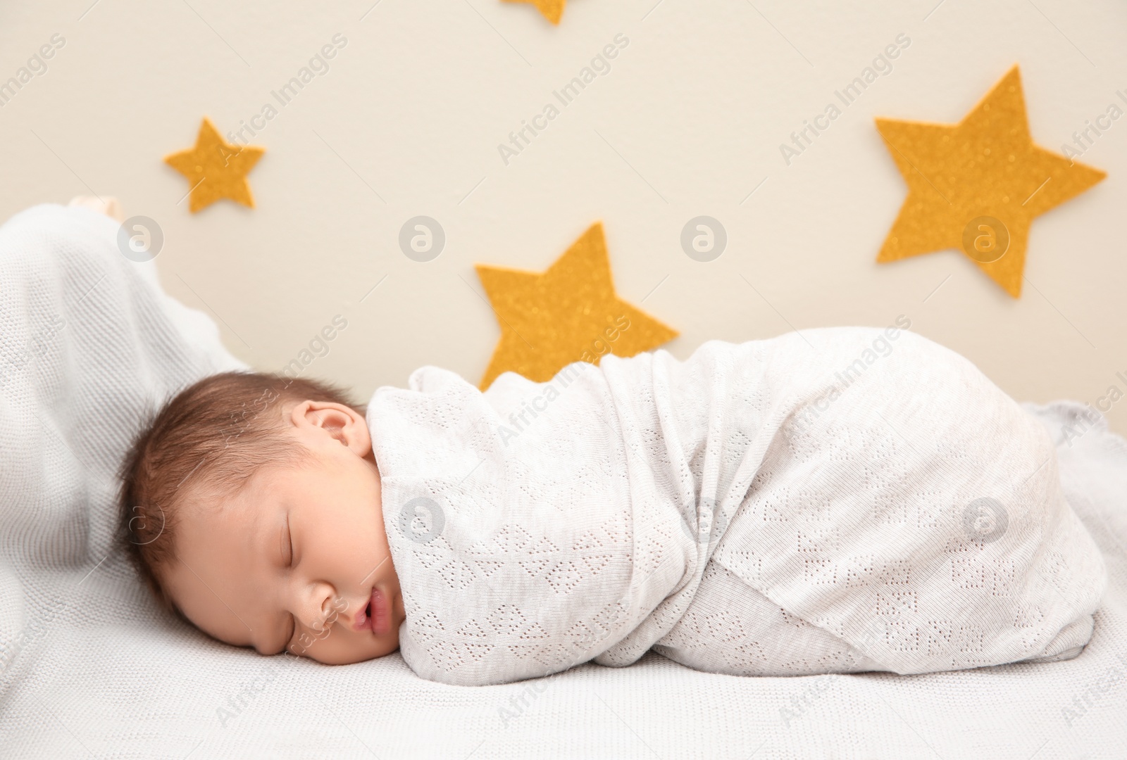 Photo of Adorable newborn baby sleeping in bed