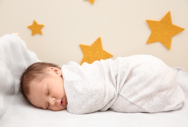Photo of Adorable newborn baby sleeping in bed