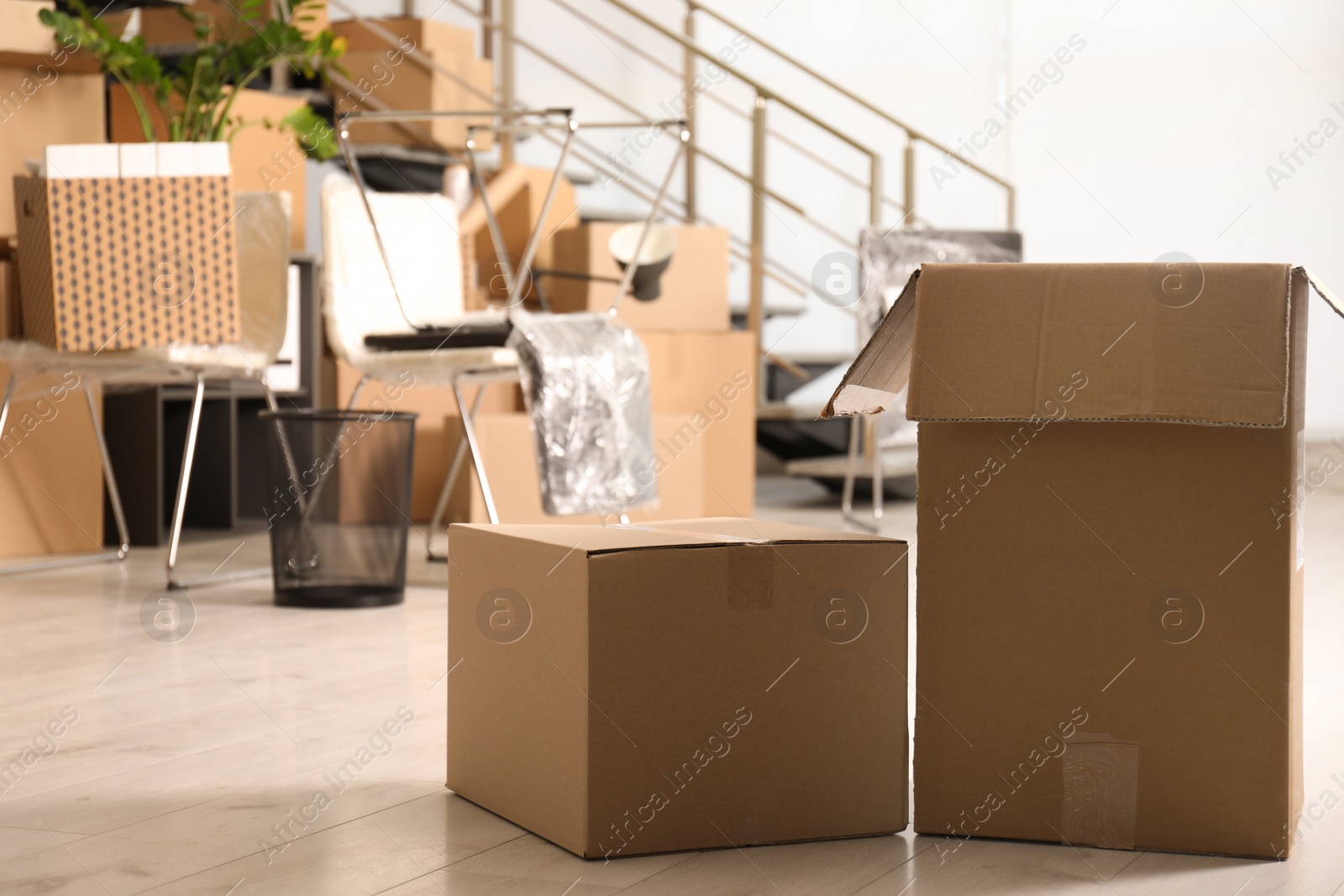 Photo of Cardboard boxes in office, space for text. Moving day