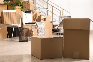 Cardboard boxes in office, space for text. Moving day