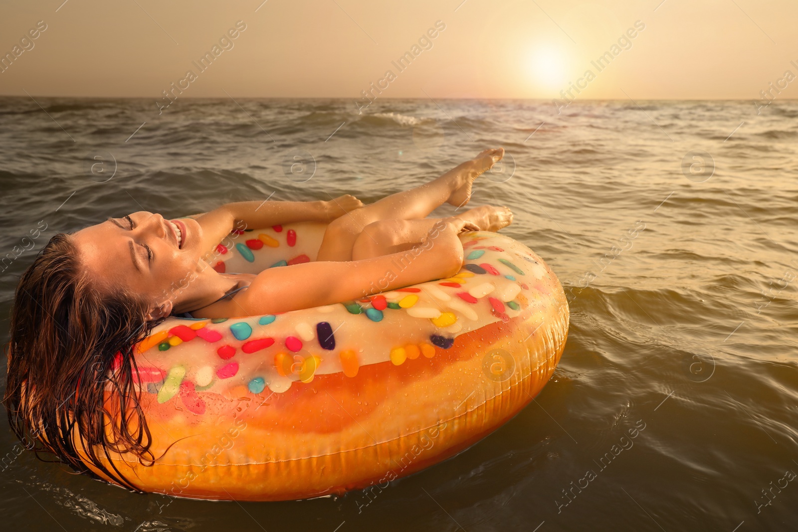 Photo of Happy woman with inflatable ring in sea