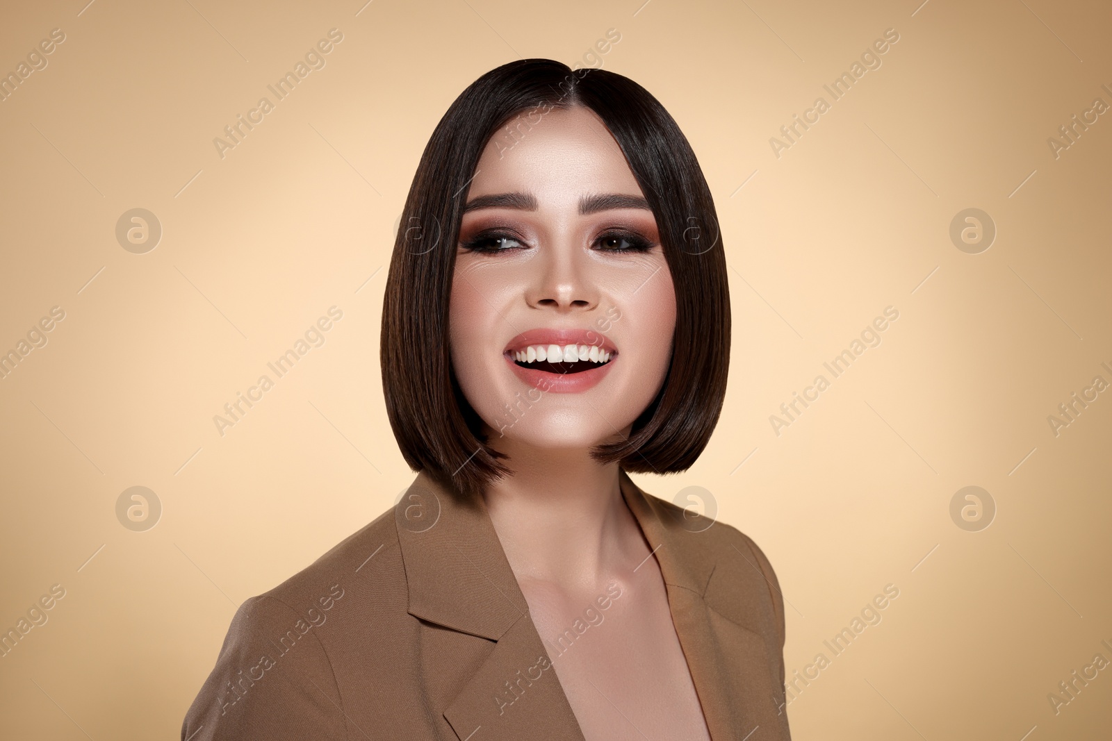 Image of Portrait of stylish pretty young woman smiling with brown hair on beige background