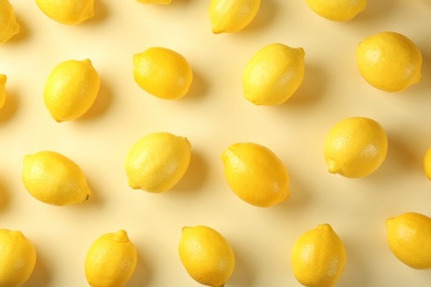 Flat lay composition with fresh ripe lemons on color background