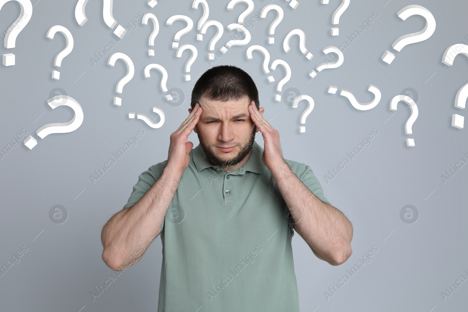 Image of Amnesia. Confused man and question marks on light grey background