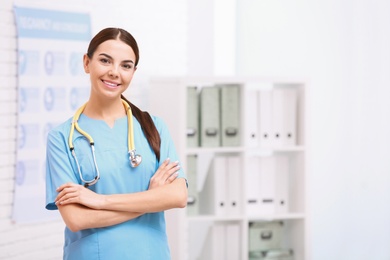 Photo of Portrait of medical assistant with stethoscope in hospital. Space for text